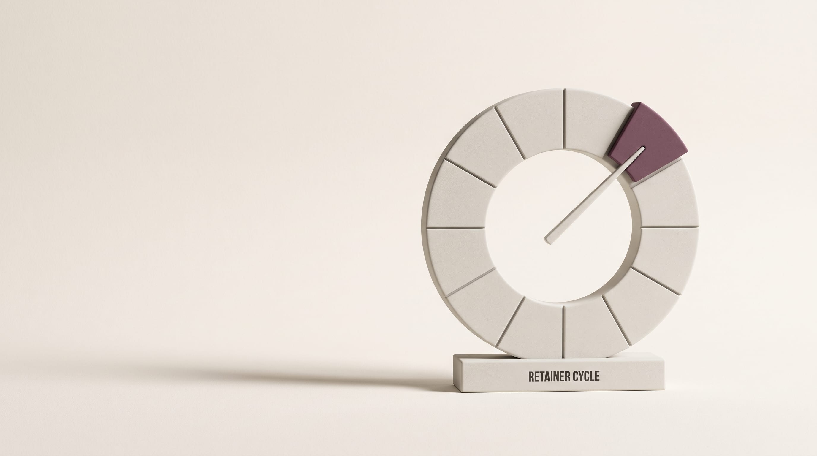 A matte porcelain twelve-segment cycle dial on a plinth reading RETAINER CYCLE, one segment in plum with the pointer resting on it